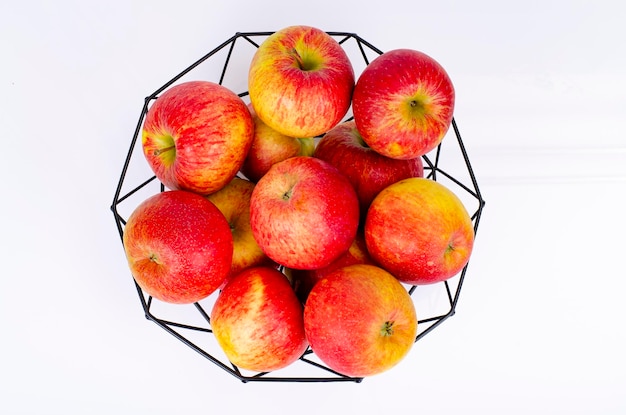 Ripe sweet apples in black metal basket. Studio Photo.