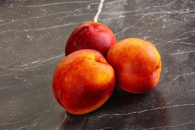 Ripe sweet juicy fresh red nectarines heap