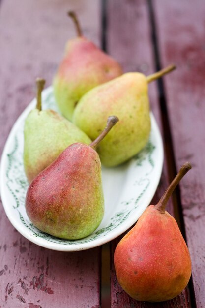 Ripe sweet pear lying on a white plate