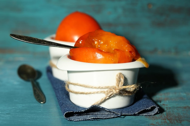 Ripe sweet persimmons on wooden table