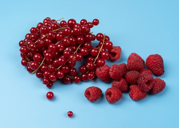 Ripe sweet raspberry with ripe red currants close up in a high resolution