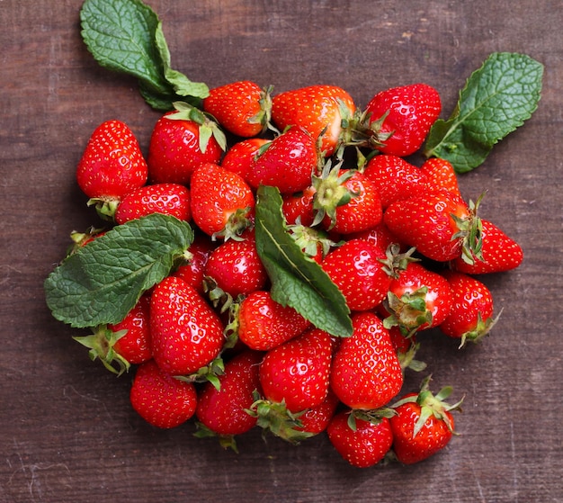 Ripe sweet strawberries on color wooden background