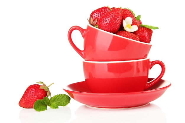 Ripe sweet strawberries in red cups isolated on white