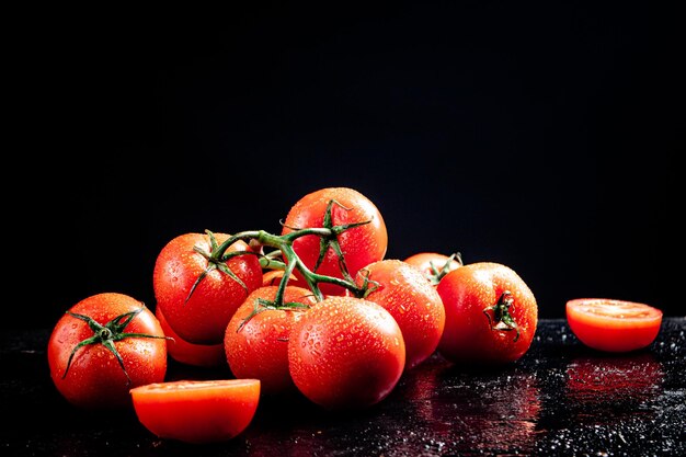 Ripe tomatoes on a branch and tomato halves