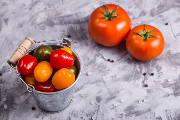 Ripe tomatoes for cooking vegetable dish on a gray