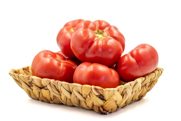 Ripe Tomatoes Fresh and raw red tomatoes in basket isolated on white background Organic food close up