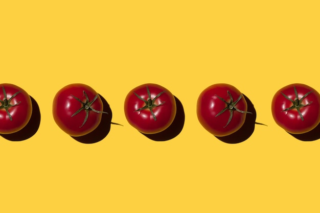 Ripe tomatoes on a yellow background Vegetables concept