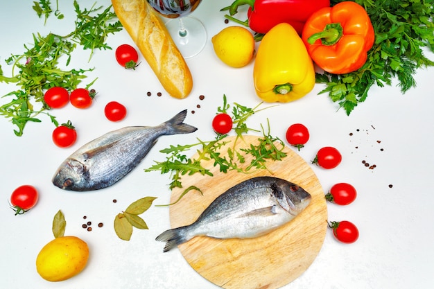 Ripe vegetables and fish on the kitchen table