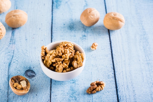 Ripe walnut kernels in a bowl on the table Organic food