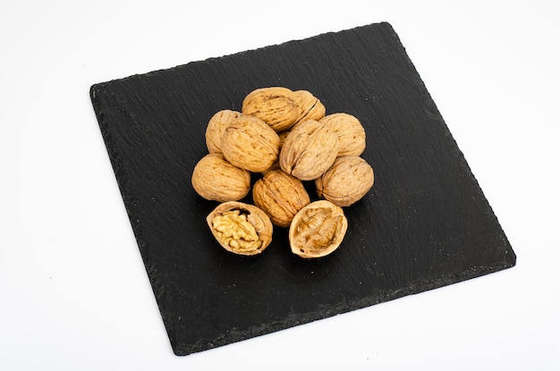 Ripe walnuts on black background. Studio Photo.