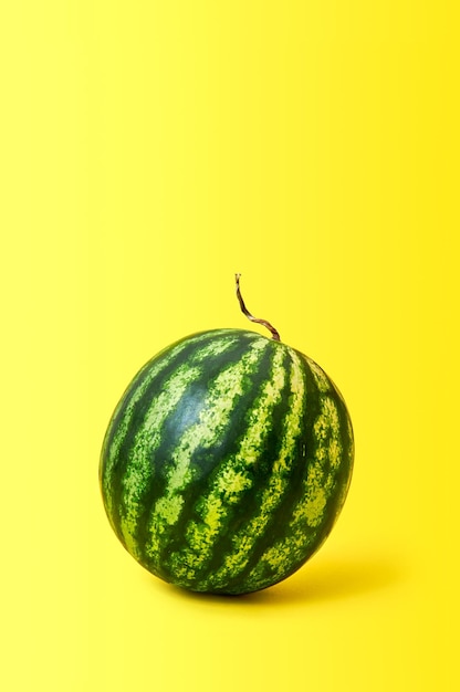 Ripe watermelon on yellow background