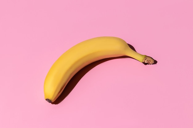 ripe yellow bananas isolated on a pink background