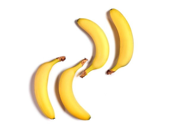 Ripe yellow bananas on a white background