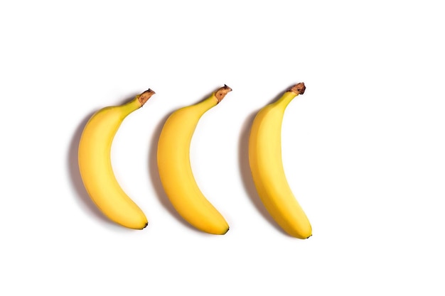 Ripe yellow bananas on a white background