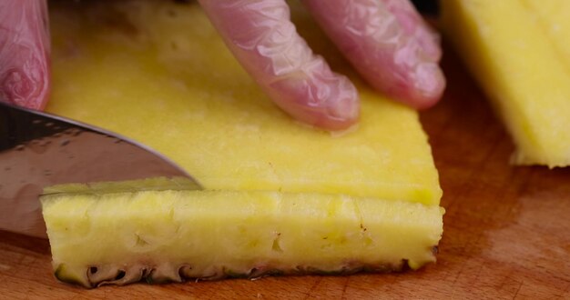 ripe yellow pineapple cut into pieces close up