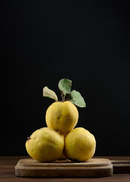 Ripe yellow quince on a wooden board