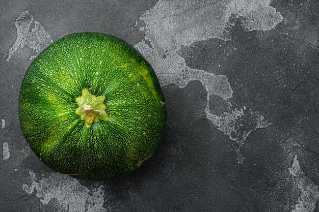 Ripe Zucchini on black dark stone table background top view flat lay with copy space for text