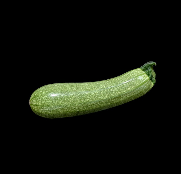 Ripe zucchini vegetable on black background