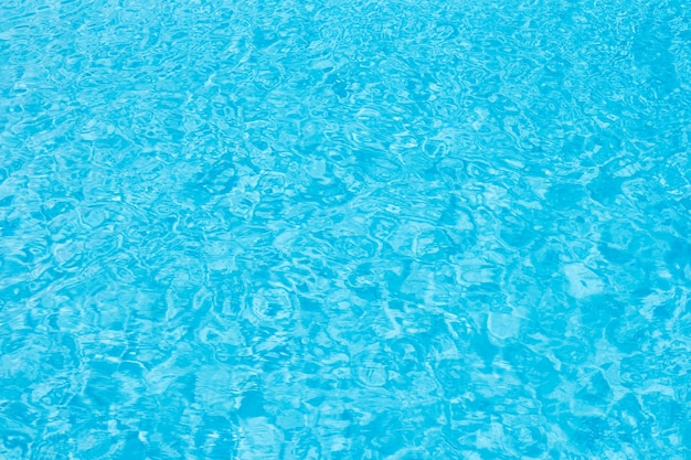 Ripple Water in swimming pool with sun reflection for background.