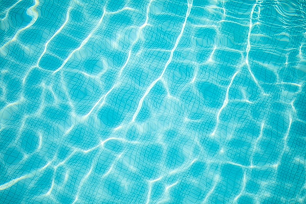 Ripple Water in swimming pool with sun reflection. Summer holiday vacation concept