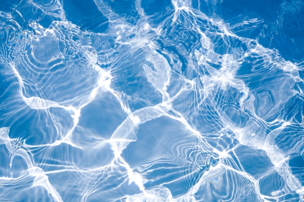 Rippled pattern of clean water in a blue swimming pool for background