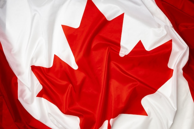 Rippled textile flag of Canada close up photo