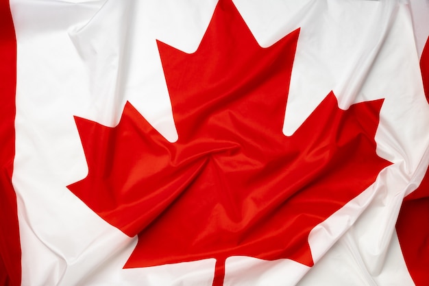 Rippled textile flag of Canada close up photo