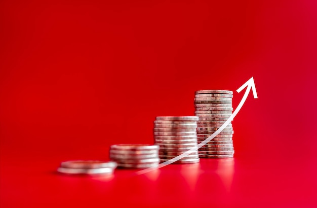 Rising arrow growing on coin stacks as graph chart steps isolated on red background Investment saving money financial income purchase trend increase inflation business marketing growth concepts