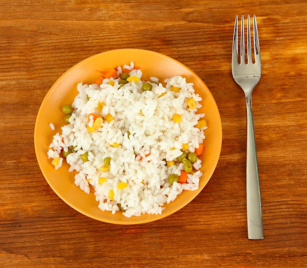 Risotto on color plate on wooden background