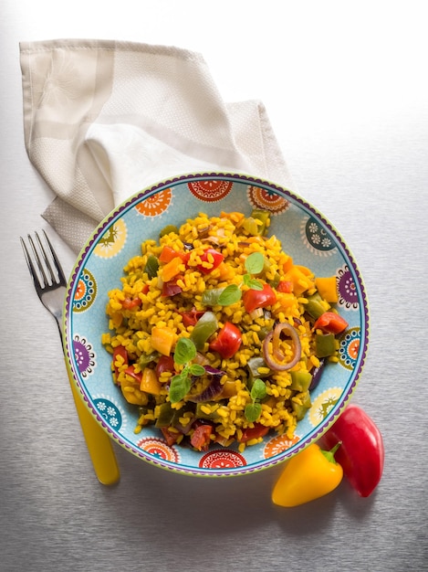 Risotto with saffron and capsicum over steel background