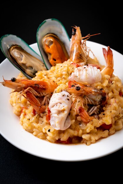 risotto with seafoods (shrimps, mussels, octopus, clams) and tomatoes