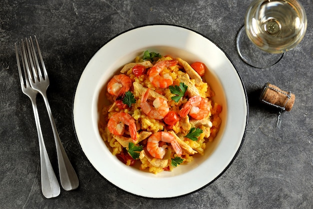 Risotto with shrimps, carrots, onions, and cherry tomatoes