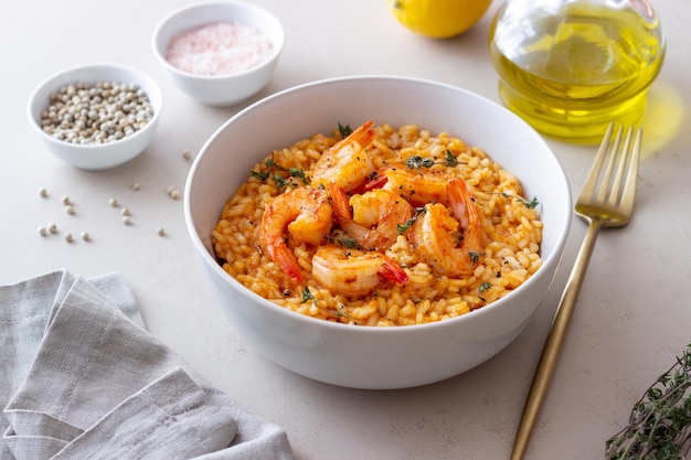 Risotto with shrimps tomatoes and thyme Italian food