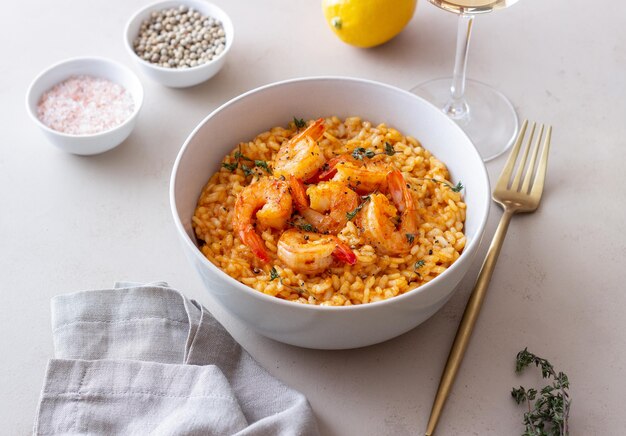 Risotto with shrimps tomatoes and thyme Italian food