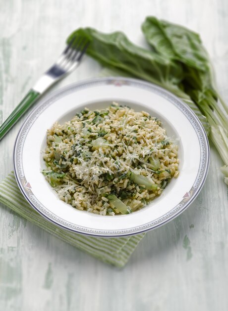 Risotto with swiss chard and parmesan cheese selective focus