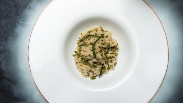 risotto with wild asparagus asparagus acutifolius on white plate