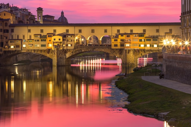 River Arno and famous bridge Ponte Vecchio at gorgeous sunset in Florence, Tuscany, Italy