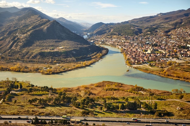 River in a blur background of mountains and villages in georgia