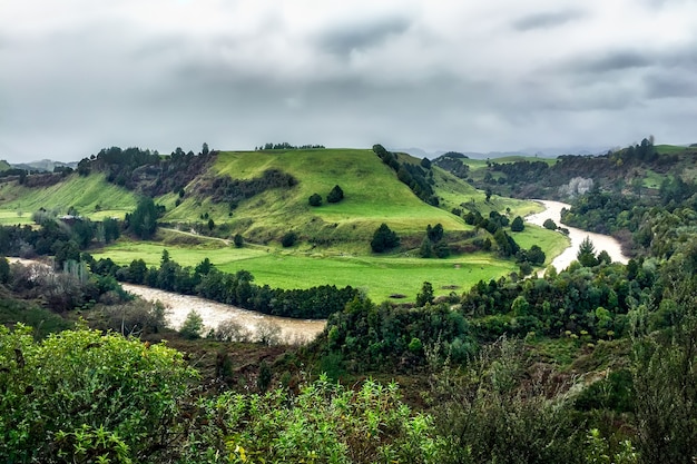 River flowing through the valley surrounded by rural hills