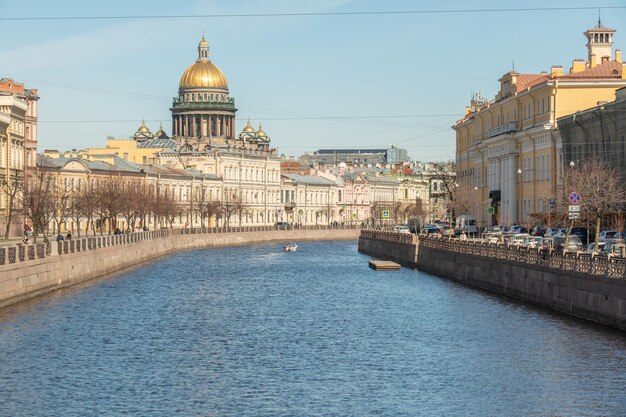 A river in st. petersburg with a gold dome on the top