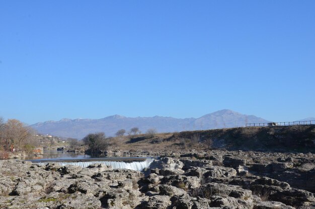 River stream with rapids and stones in the spring on a sunny day