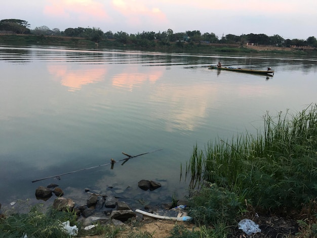 River in Thailand Fishing boats Fish along the river Sunset or sunrise Garbage in the river sea beach sunset