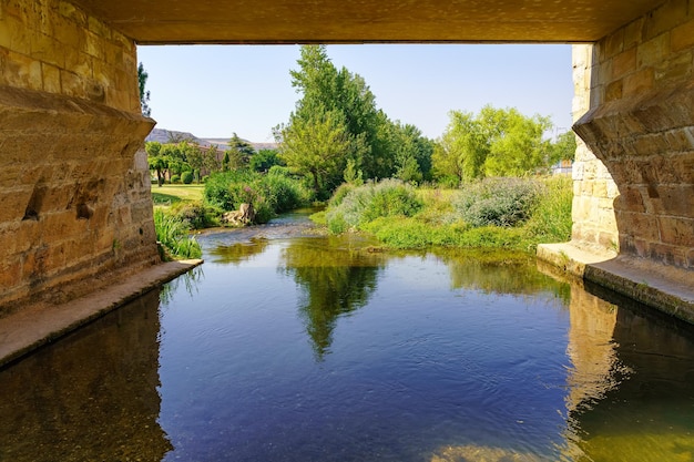 River Ucero passing under the medieval bridge that gives entrance to the old city of Burgo de Osma