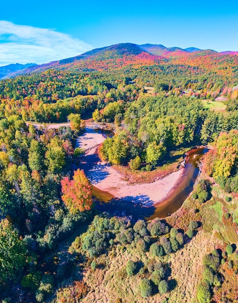 River winding through lush forests and mountains of New York in peak fall