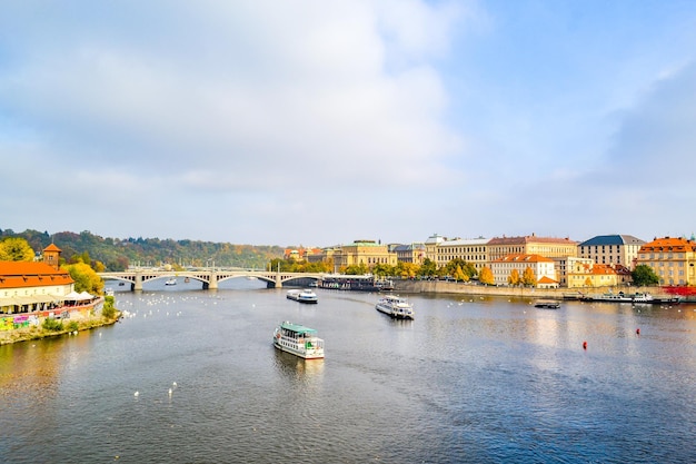 a river with boats and a bridge in the background Czech Republic Prague Sights buildings Vltava