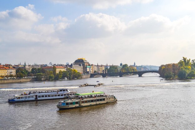 a river with boats and a bridge in the background Czech Republic Prague Sights buildings Vltava