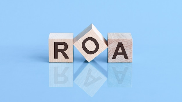 ROA is an abbreviation of the Return On Assets- the text is written on wooden cubes