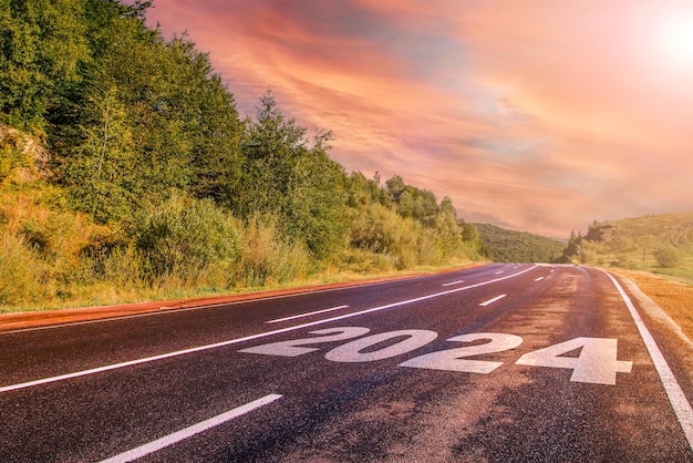 Road 2024 the road leads to the mountains at sunrise road trip travel and future vision concept