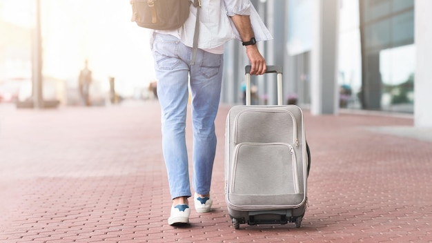 Road To Airport Unrecognizable Man Walking With Suitcase And Backpack Outdoors