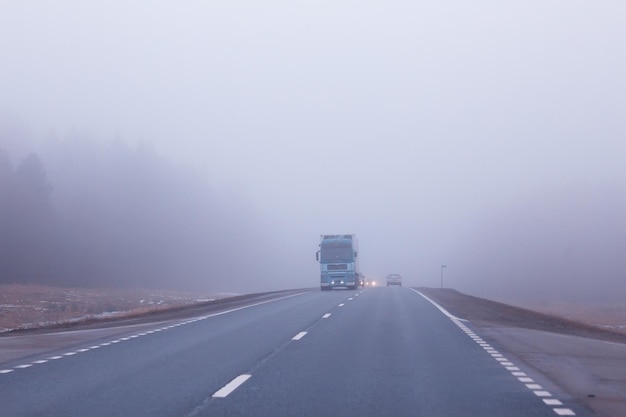 road in fog concept, mist in october halloween landscape, highway